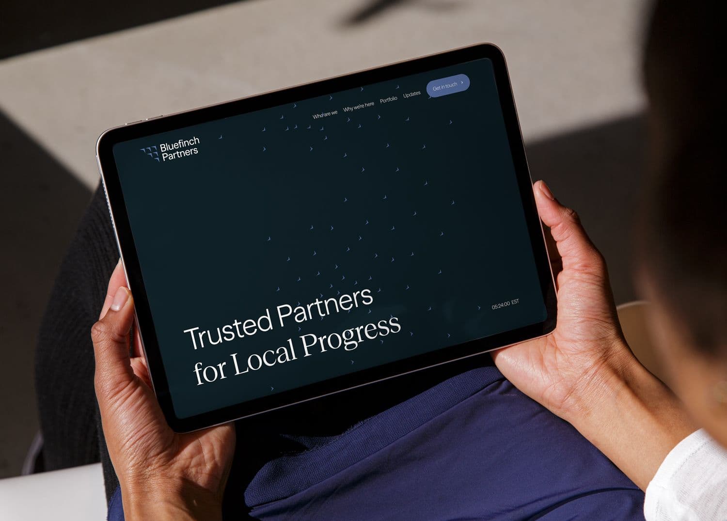 A tablet device showcasing a website design for investment firm, Bluefinch Partners. The brand identity uses tones of blue and a distinctive flocking bird graphic.